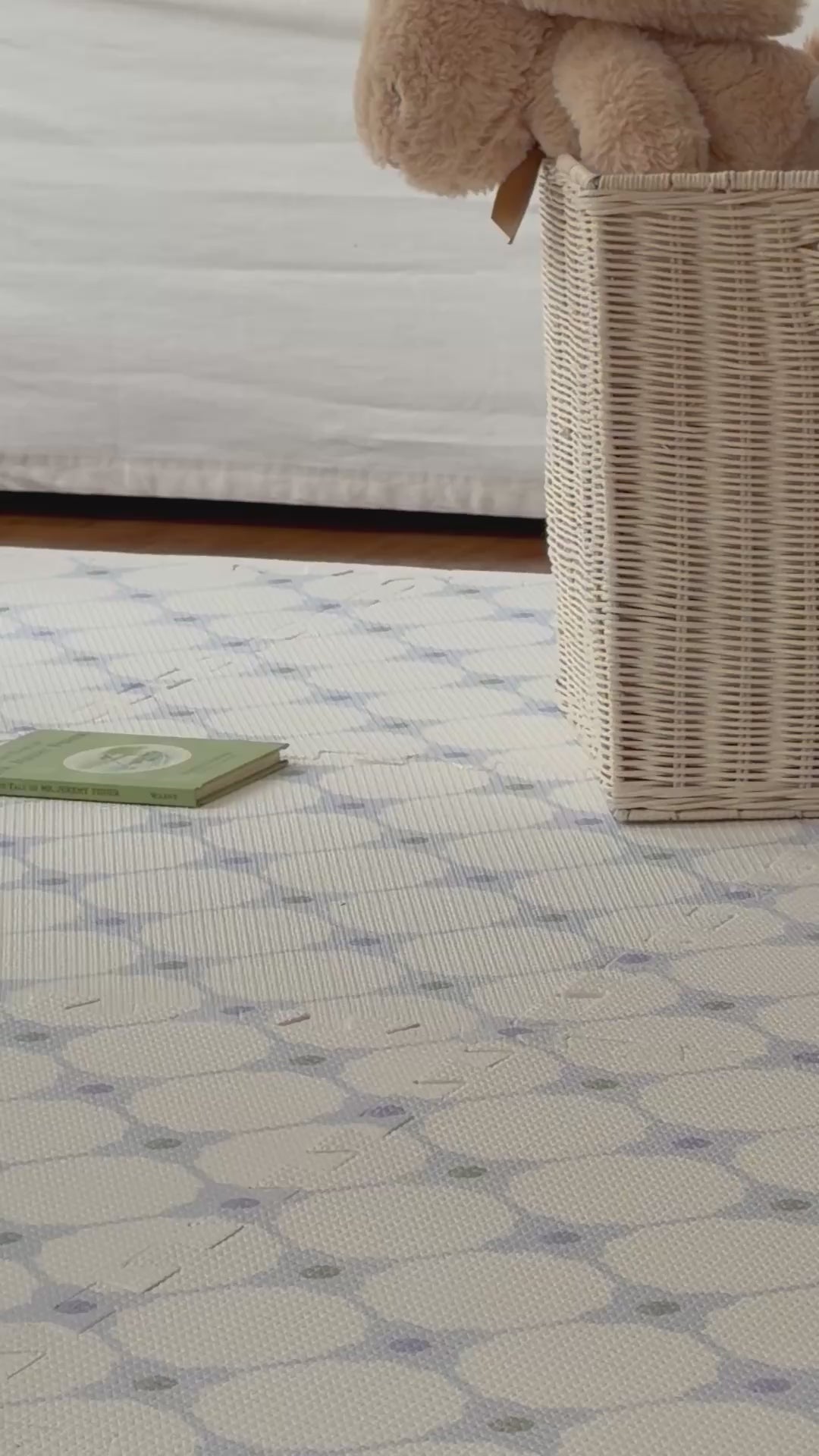 Vídeo de um adulto andando sobre o tapetinho Flower Power azul montado, com cachorrinho de pelúcia de balanço ao fundo